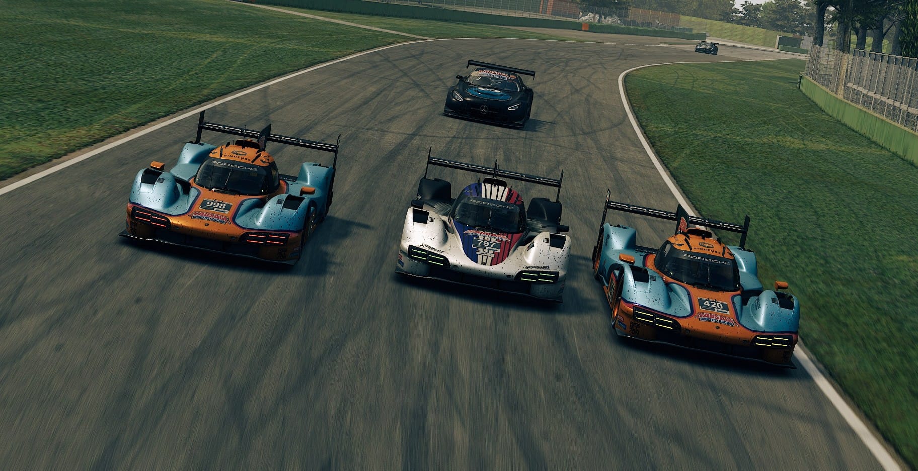 LMP prototypes in close formation through a sweeping corner